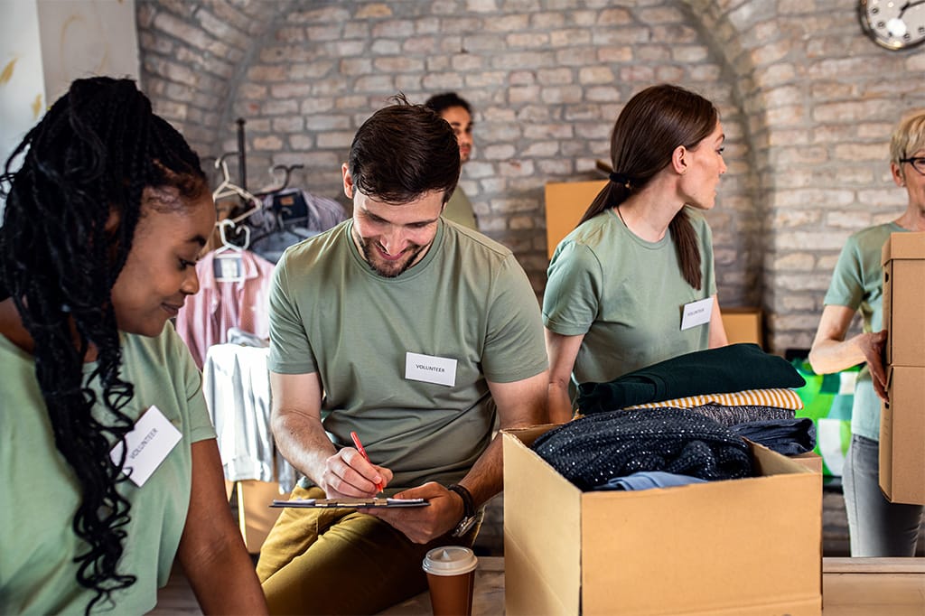 Team sorting clothes into boxes